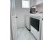 Functional laundry room includes a window and modern, white washer and dryer at 3805 Carisbrook Dr, North Las Vegas, NV 89081