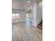 Open living space features wood-look tile floors and natural light from a large window at 3805 Carisbrook Dr, North Las Vegas, NV 89081