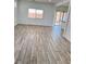 Spacious living room with wood-look tile flooring and natural light at 3805 Carisbrook Dr, North Las Vegas, NV 89081