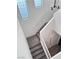 Carpeted staircase with views of the open foyer and windows at 3805 Carisbrook Dr, North Las Vegas, NV 89081