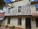 Two-story townhome featuring a stucco exterior, tiled roof, windows with security bars, and secure front door at 3967 Visby Ln, Las Vegas, NV 89119