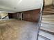 Spacious carpeted living room featuring a staircase and a partial wall mirror at 3967 Visby Ln, Las Vegas, NV 89119