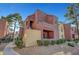 Multi-level apartment complex features a unique architectural style and well-maintained landscaping at 4050 Pacific Harbors Dr # 233, Las Vegas, NV 89121