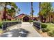 Building entrance surrounded by manicured landscaping, a bridge, and walkways at 4050 Pacific Harbors Dr # 233, Las Vegas, NV 89121