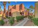 Exterior of a residential building showcasing mature trees and landscaping at 4050 Pacific Harbors Dr # 233, Las Vegas, NV 89121