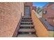Exterior stairs leading to the second floor condo with gray entry door at 4050 Pacific Harbors Dr # 233, Las Vegas, NV 89121
