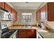 Galley-style kitchen features granite countertops, stainless steel appliances, and ample cabinet space at 4050 Pacific Harbors Dr # 233, Las Vegas, NV 89121