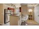 Well-lit kitchen with bar seating, stainless steel appliances, and storage at 4050 Pacific Harbors Dr # 233, Las Vegas, NV 89121