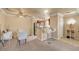 Cozy living room with a small kitchen, breakfast bar, and neutral color palette at 4050 Pacific Harbors Dr # 233, Las Vegas, NV 89121