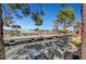A well-maintained, covered parking lot surrounded by mature trees on a sunny day at 4050 Pacific Harbors Dr # 233, Las Vegas, NV 89121
