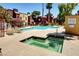 Resort-style pool area with sun loungers, palm trees, spa and clear blue water at 4050 Pacific Harbors Dr # 233, Las Vegas, NV 89121