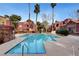 Community pool featuring clear blue water, lounge chairs, and nearby seating areas at 4050 Pacific Harbors Dr # 233, Las Vegas, NV 89121