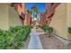 Exterior walkway with landscaped areas, leading to residential units at 4050 Pacific Harbors Dr # 233, Las Vegas, NV 89121