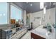 Bright bathroom features dual sinks, marble countertops, elegant lighting, and glass-enclosed shower at 4471 Dean Martin Dr # 2101, Las Vegas, NV 89103
