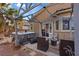 Backyard with covered seating area, hot tub, and palm tree at 4632 Cantina Rey St, North Las Vegas, NV 89081