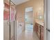 Spacious bathroom with tub shower combo, vanity with sink, and peach walls at 4632 Cantina Rey St, North Las Vegas, NV 89081