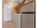A bright laundry room featuring a washer and dryer, plus extra fridge and storage at 4632 Cantina Rey St, North Las Vegas, NV 89081