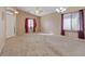 Spacious living room with carpet, neutral walls, a ceiling fan, and natural light coming through the window at 4632 Cantina Rey St, North Las Vegas, NV 89081