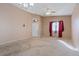 Bright living room with carpet, neutral paint, and natural light coming through the front door window at 4632 Cantina Rey St, North Las Vegas, NV 89081
