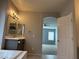 Bathroom vanity featuring an arched entryway to an additional room at 4912 Capo Gallo St, Las Vegas, NV 89130