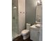 Modern bathroom with glass shower, tile accent wall, toilet and modern white vanity at 4912 Capo Gallo St, Las Vegas, NV 89130