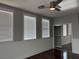 Bright bedroom with three windows, ceiling fan, and closet with mirrored sliding doors at 4912 Capo Gallo St, Las Vegas, NV 89130