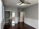 Bedroom with wood floors, mirrored closet, and wainscotting at 4912 Capo Gallo St, Las Vegas, NV 89130