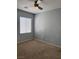 Bedroom with neutral carpet, a ceiling fan, and a window for natural light at 4912 Capo Gallo St, Las Vegas, NV 89130