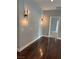 Hallway featuring hardwood floors, decorative sconces, and access to rooms at 4912 Capo Gallo St, Las Vegas, NV 89130