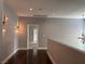 Hallway featuring hardwood floors, decorative lighting, and access to rooms at 4912 Capo Gallo St, Las Vegas, NV 89130