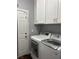 Functional laundry room with modern washer and dryer units, plus overhead storage at 4912 Capo Gallo St, Las Vegas, NV 89130
