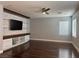 Well-lit living room boasts a custom entertainment center and sleek hardwood floors at 4912 Capo Gallo St, Las Vegas, NV 89130