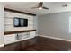 Stylish living room with a custom entertainment center and sleek hardwood floors at 4912 Capo Gallo St, Las Vegas, NV 89130