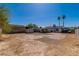 Large backyard with gravel, shed, palm trees, and patio area at 5582 Tunis Ave, Las Vegas, NV 89122