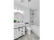 Bathroom with vanity, updated fixtures, round mirror, and tub-shower combo with stone surround at 5582 Tunis Ave, Las Vegas, NV 89122