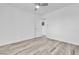 Bright bedroom with wood-look floors, ceiling fan and white door at 5582 Tunis Ave, Las Vegas, NV 89122