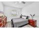 Bedroom featuring a ceiling fan, gray comforter, and wood-look flooring at 5582 Tunis Ave, Las Vegas, NV 89122