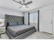Bedroom featuring a tufted headboard, neutral color palette and a ceiling fan at 5582 Tunis Ave, Las Vegas, NV 89122