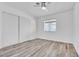 Bedroom with a ceiling fan, wood-look floors, and a sliding door closet at 5582 Tunis Ave, Las Vegas, NV 89122