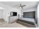 Bedroom with a tufted headboard, ceiling fan, and light colored dresser set at 5582 Tunis Ave, Las Vegas, NV 89122