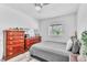 Bedroom showcasing wood-look floors, dresser set and gray comforter at 5582 Tunis Ave, Las Vegas, NV 89122