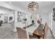 Dining room featuring a table with seating, a chandelier above, and views to the modern kitchen at 5582 Tunis Ave, Las Vegas, NV 89122