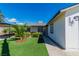 Landscaped front yard with lush green lawn, decorative gravel, and a well-maintained house exterior at 5582 Tunis Ave, Las Vegas, NV 89122