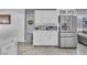 Bright kitchen featuring white cabinets, stainless steel fridge, and marble countertops at 5582 Tunis Ave, Las Vegas, NV 89122