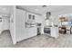 Bright kitchen featuring white cabinetry, stainless appliances, and a breakfast bar overlooking the dining area at 5582 Tunis Ave, Las Vegas, NV 89122