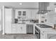Clean white kitchen with stainless steel appliances and marble countertops at 5582 Tunis Ave, Las Vegas, NV 89122
