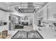 Bright kitchen showcasing white cabinets, stainless steel appliances, marble counters, and open floor concept at 5582 Tunis Ave, Las Vegas, NV 89122