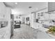 Modern kitchen showcasing open floor plan, white cabinets, marble countertops, and stainless steel appliances at 5582 Tunis Ave, Las Vegas, NV 89122