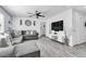 Spacious living room featuring gray sectional, wood-look floors, and modern decor at 5582 Tunis Ave, Las Vegas, NV 89122