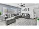 Cozy living room with a large sectional couch, wood-look floors, and modern wall decor at 5582 Tunis Ave, Las Vegas, NV 89122